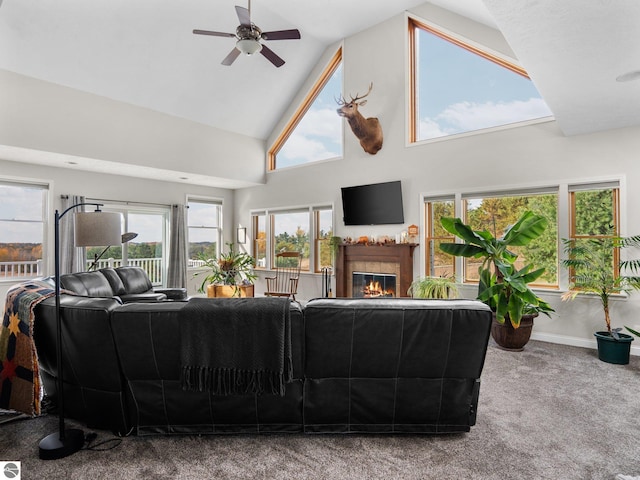 living room with ceiling fan, high vaulted ceiling, and carpet flooring