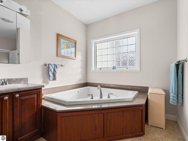 bathroom with vanity, a bathtub, and tile patterned flooring