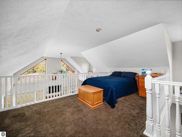 carpeted bedroom with lofted ceiling and a textured ceiling