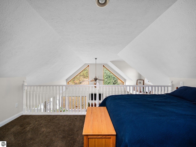 carpeted bedroom featuring a textured ceiling and vaulted ceiling