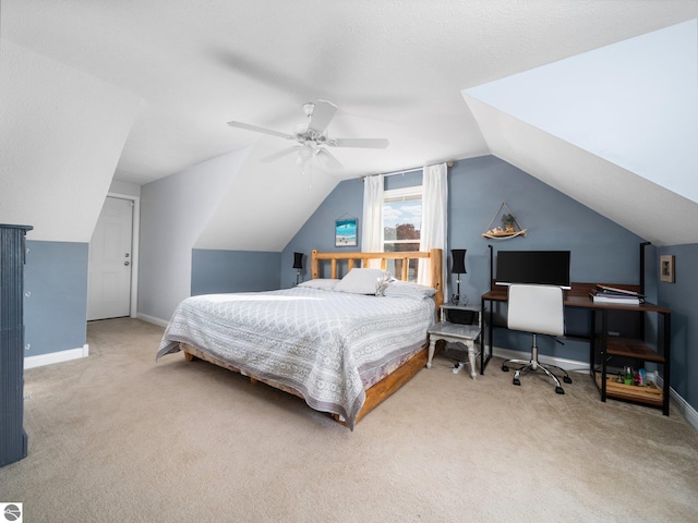 carpeted bedroom with vaulted ceiling and ceiling fan