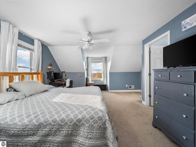 carpeted bedroom with ceiling fan, lofted ceiling, and multiple windows