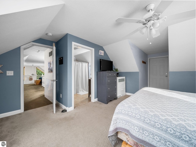 carpeted bedroom with vaulted ceiling and ceiling fan