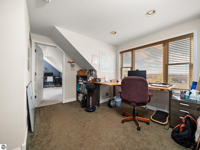 office area featuring a textured ceiling and dark carpet