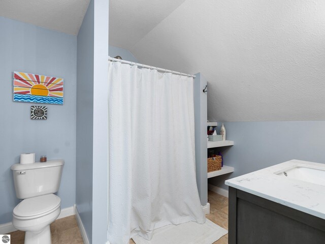 bathroom featuring tile patterned floors, toilet, vaulted ceiling, vanity, and a textured ceiling