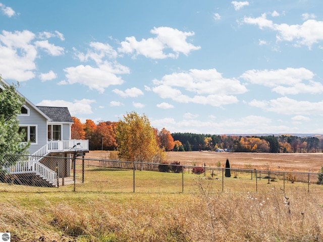 view of yard featuring a wooden deck and a rural view