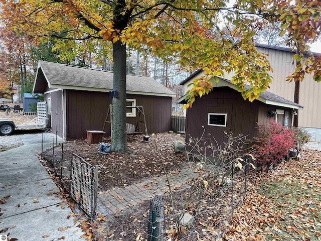 view of property exterior featuring a storage shed