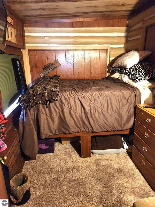 bedroom with wood ceiling, wooden walls, and carpet