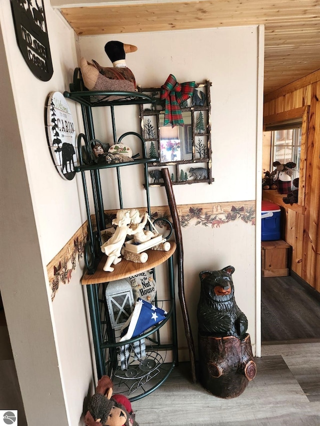 room details with wood-type flooring and wooden walls