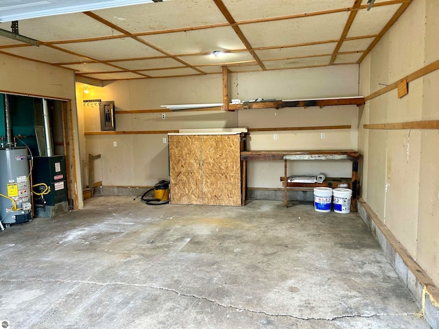 garage featuring electric panel and gas water heater