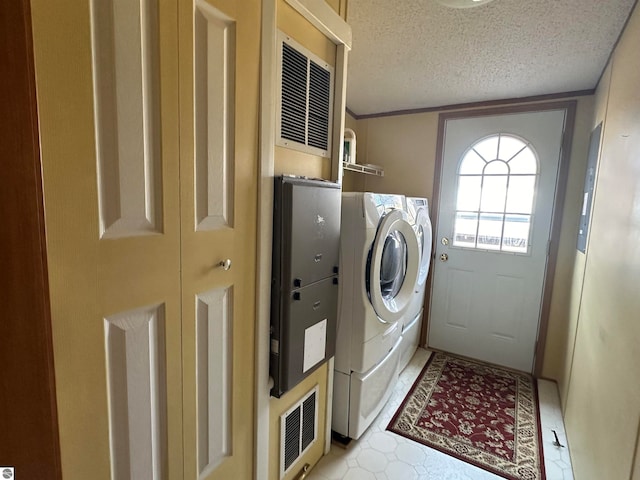 laundry room with laundry area, independent washer and dryer, and a textured ceiling