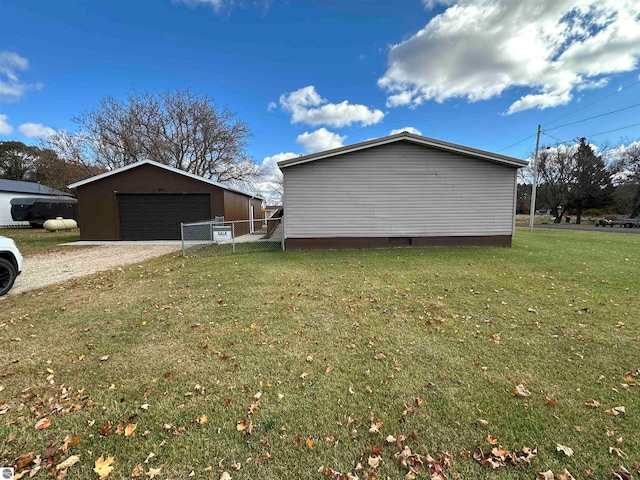 view of property exterior with an outbuilding, fence, a yard, crawl space, and a detached garage