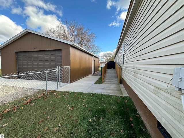 view of property exterior with a gate, a garage, an outdoor structure, and fence