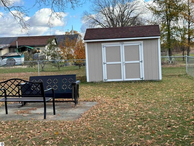 view of shed featuring fence