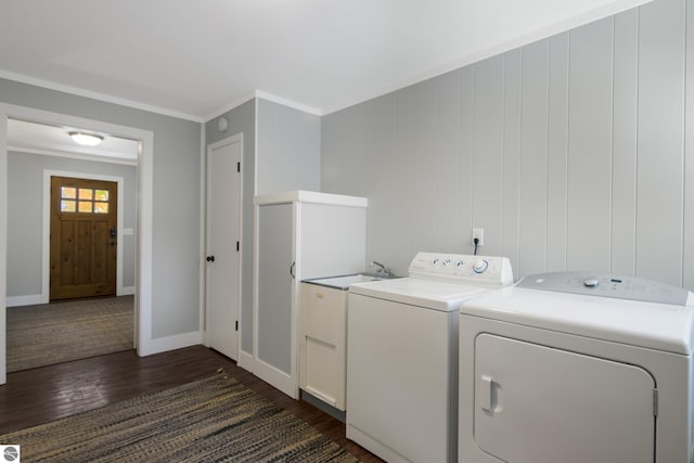 laundry area with sink, independent washer and dryer, dark hardwood / wood-style flooring, crown molding, and cabinets