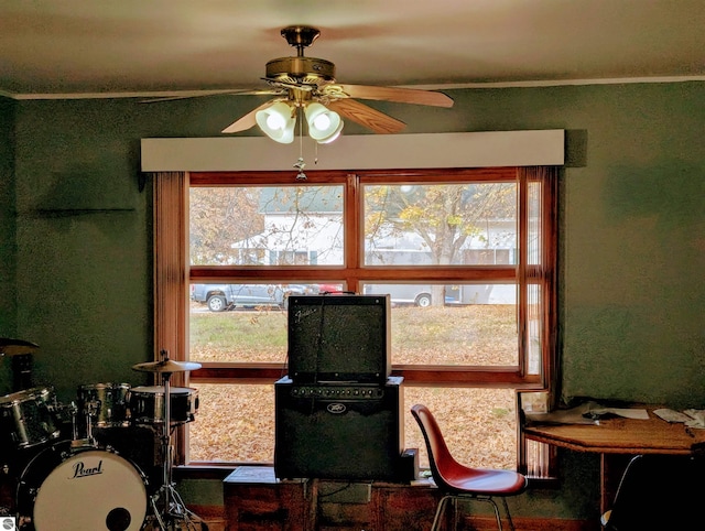 dining space featuring ornamental molding and ceiling fan