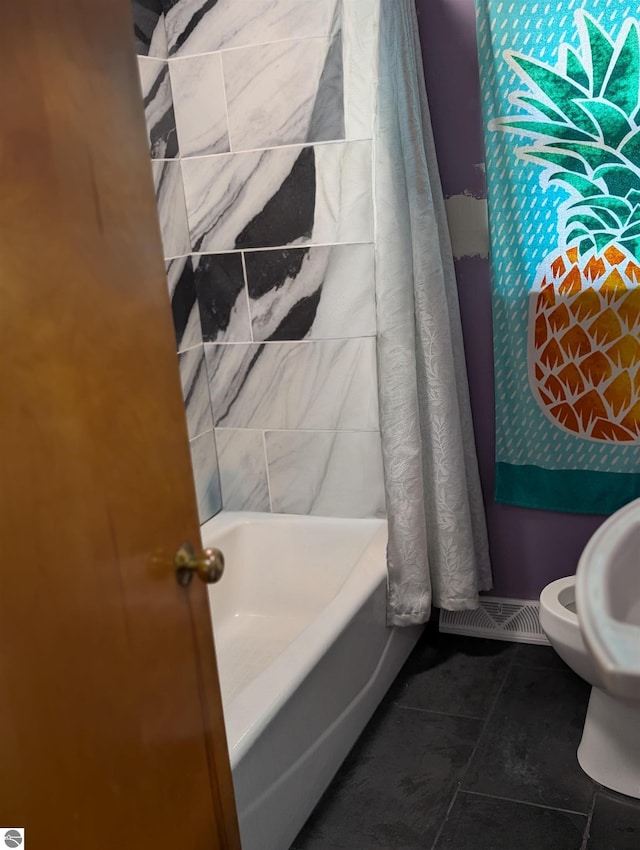 bathroom featuring toilet and tile patterned flooring