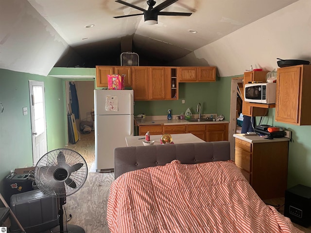 kitchen with white appliances, ceiling fan, lofted ceiling, and sink