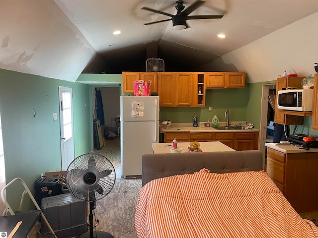 kitchen with lofted ceiling, hardwood / wood-style floors, sink, white appliances, and ceiling fan