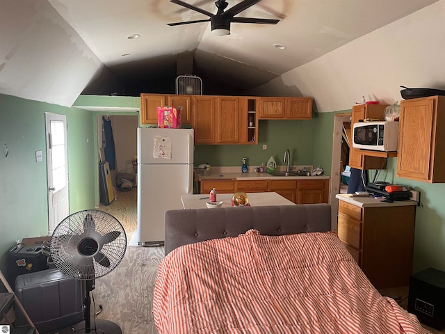 kitchen featuring white fridge, ceiling fan, lofted ceiling, and sink