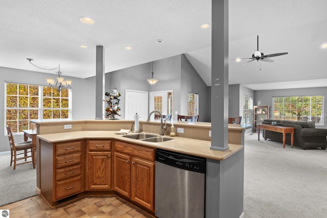 kitchen featuring dishwasher, hanging light fixtures, a center island with sink, sink, and light colored carpet