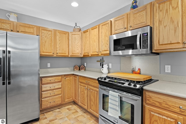 kitchen featuring appliances with stainless steel finishes and light brown cabinets