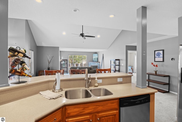 kitchen featuring lofted ceiling, carpet, ceiling fan, dishwasher, and sink