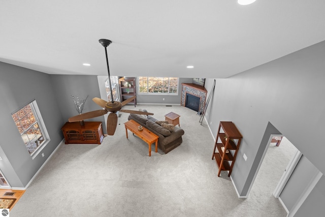 living room with ceiling fan and light colored carpet