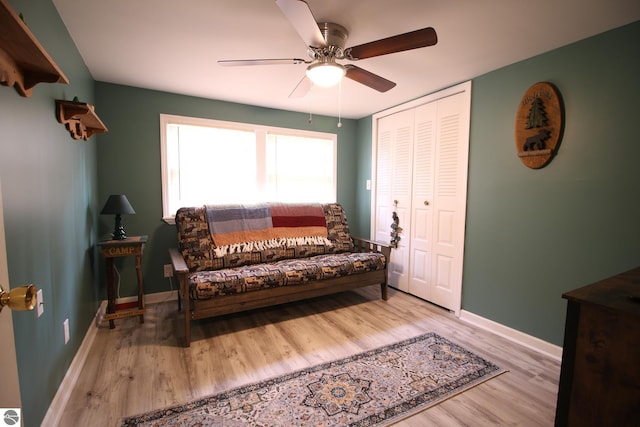 sitting room featuring ceiling fan, wood finished floors, and baseboards