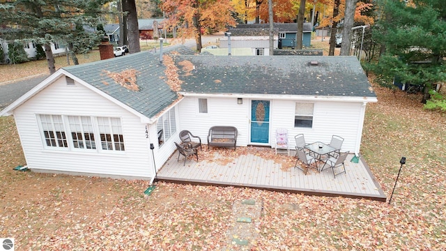 rear view of property featuring a wooden deck