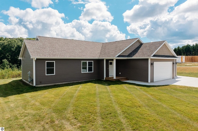 view of front of property with a front lawn and a garage