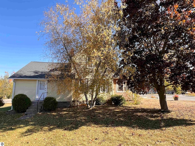 obstructed view of property featuring a front lawn