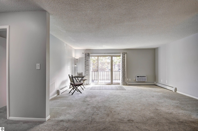 carpeted empty room with a baseboard heating unit, a wall unit AC, and a textured ceiling