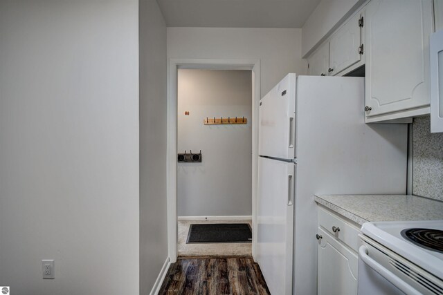 kitchen featuring dark wood-type flooring, white cabinets, and white range oven