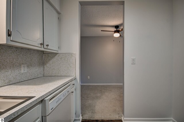 kitchen featuring dishwasher, a textured ceiling, carpet floors, ceiling fan, and decorative backsplash