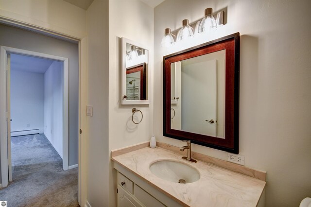 bathroom with vanity and baseboard heating