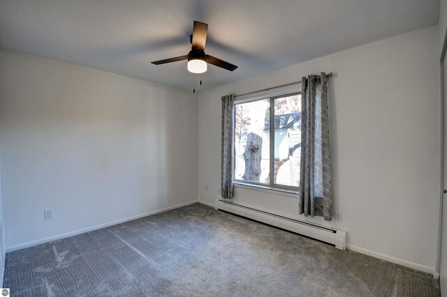 empty room featuring carpet floors, baseboard heating, and ceiling fan