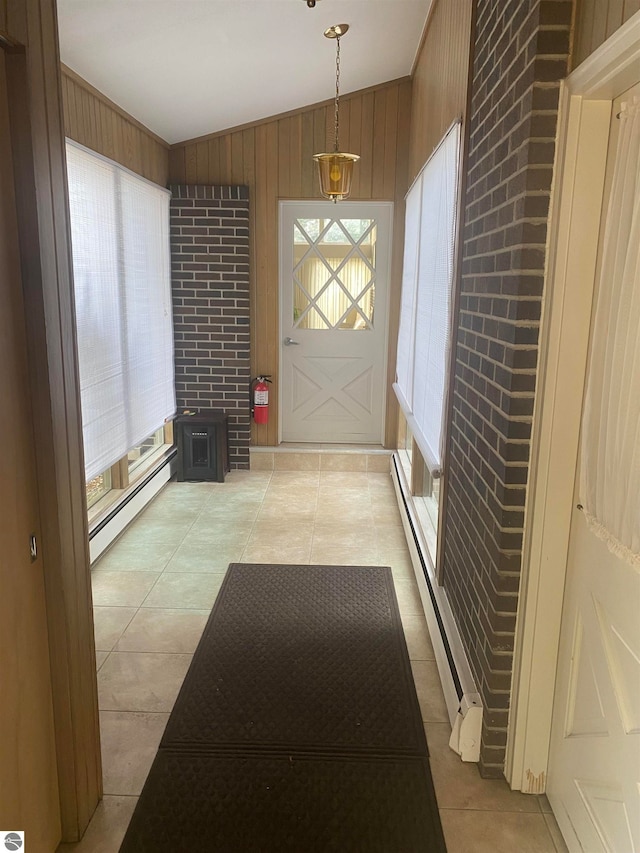 entryway with a baseboard radiator, vaulted ceiling, and plenty of natural light