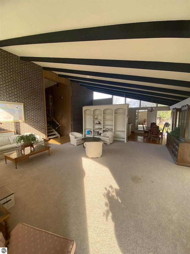 unfurnished living room with carpet floors and lofted ceiling with beams