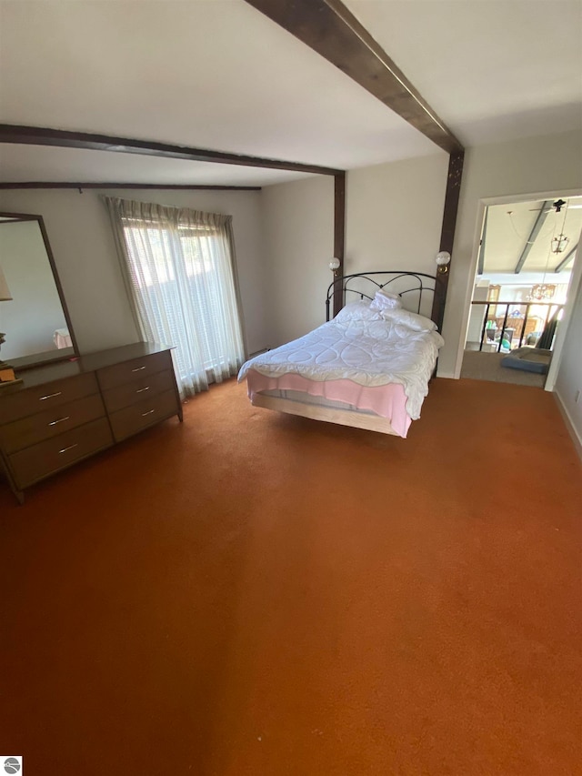 unfurnished bedroom featuring beamed ceiling and carpet floors