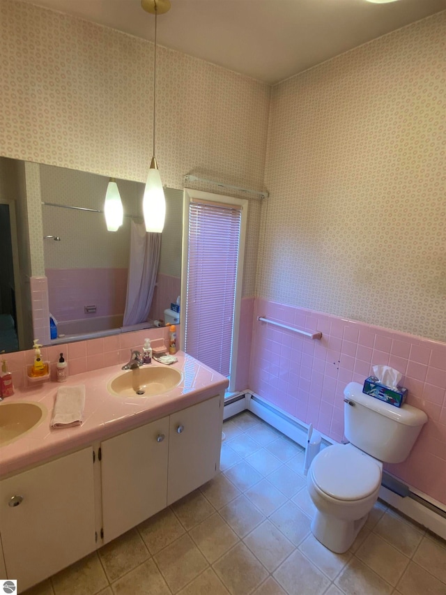 bathroom with toilet, a baseboard heating unit, vanity, and tile walls