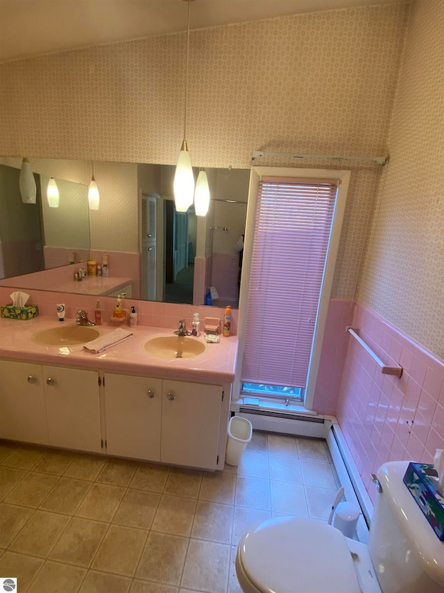 bathroom featuring toilet, vanity, tile walls, and tile patterned flooring