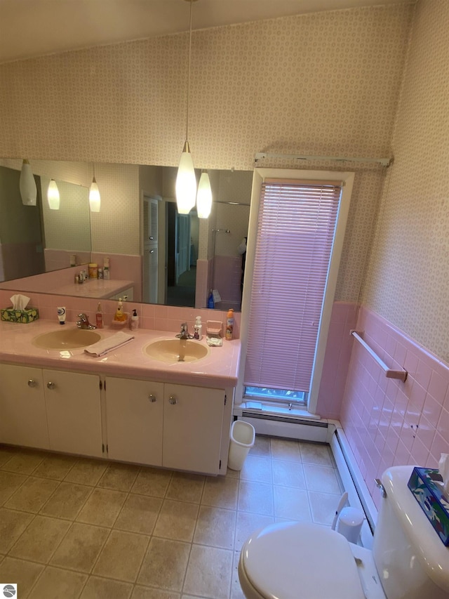 616 Holiday Dr, Bellaire, MI 49615 - full bathroom with toilet, tile walls, a baseboard radiator, tile patterned floors, and double vanity