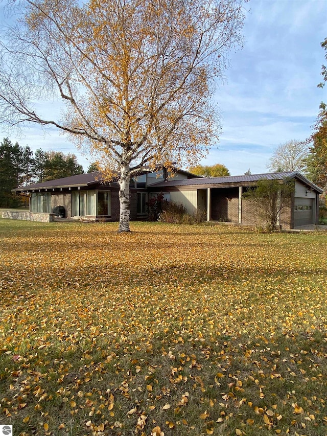 view of front of home with a front yard and a garage