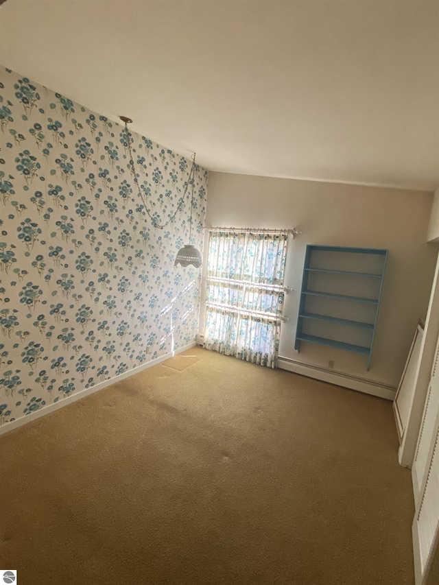 616 Holiday Dr, Bellaire, MI 49615 - spare room featuring carpet floors, a baseboard radiator, wallpapered walls, and baseboards
