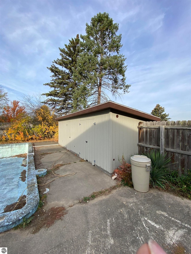 view of home's exterior with a swimming pool