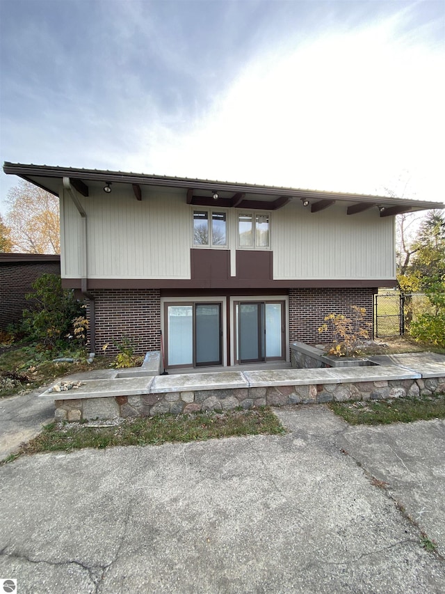 616 Holiday Dr, Bellaire, MI 49615 - back of property featuring brick siding
