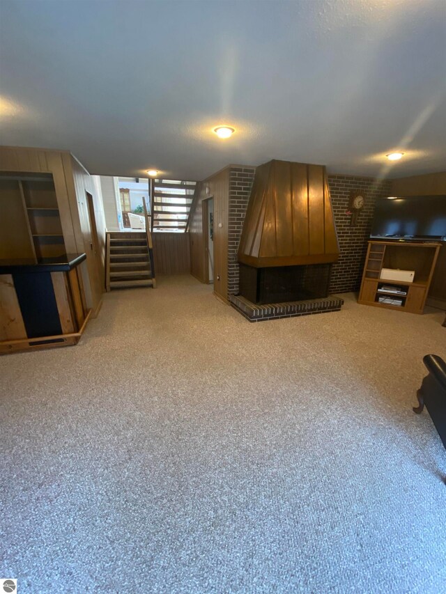 basement featuring carpet floors and brick wall