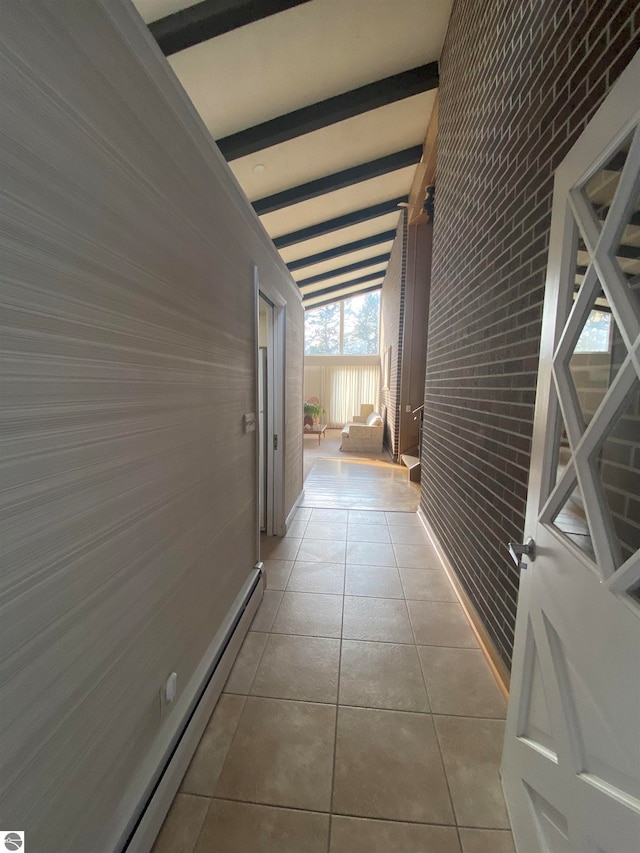 corridor featuring vaulted ceiling with beams, a baseboard heating unit, brick wall, and light tile patterned floors