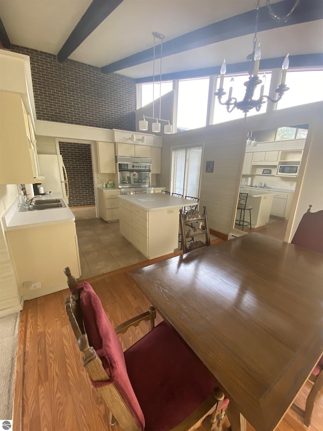 616 Holiday Dr, Bellaire, MI 49615 - dining space with a chandelier and light wood-type flooring